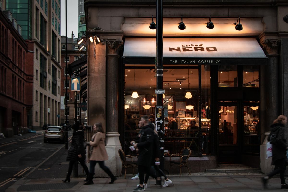 Moderne kaffebar i Danmark med store vinduer og gæster udenfor